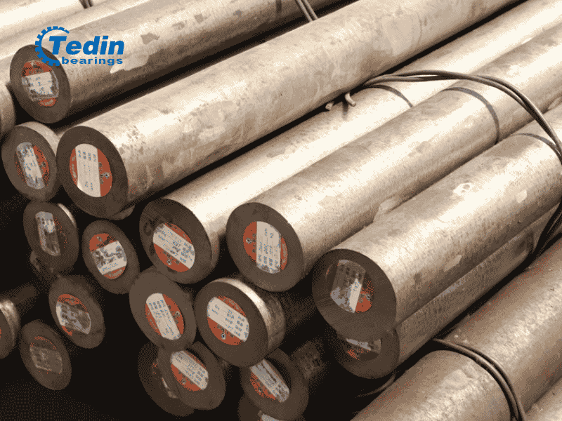Stack of high-purity chrome bearing steel rods used as raw material for our bearings.