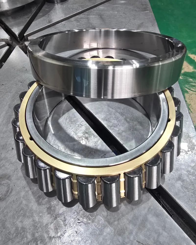 Internal components of a tapered roller bearings, showing the separable outer ring (cup), inner ring (cone), rollers, and a brass cage.