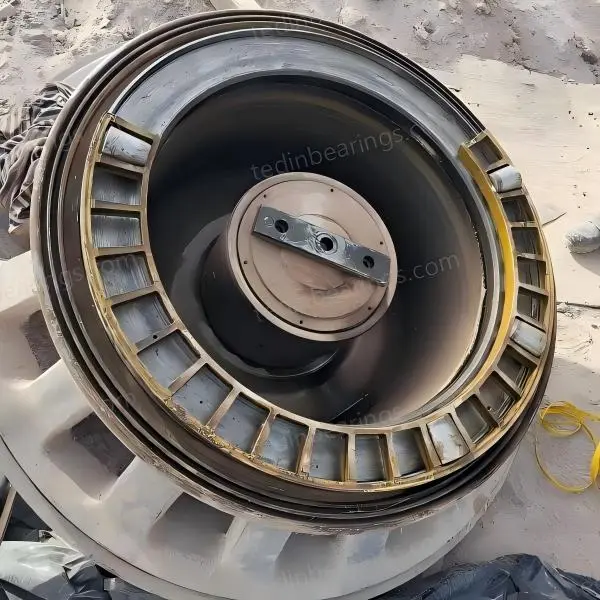 Failed cone crusher bearing with roller and raceway damage