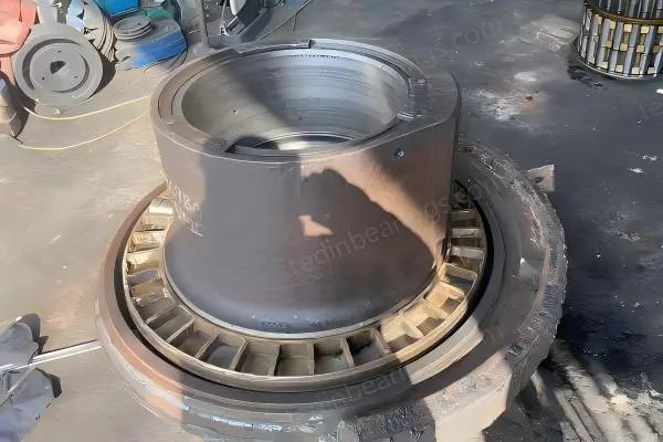 Failed main bearing removed from Cedarapids RC54 cone crusher on customer site