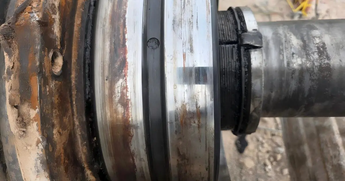 Technician removing a bearing from a crusher shaft