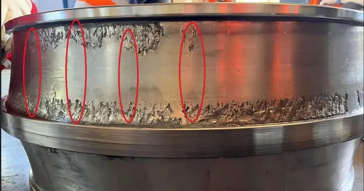 Failed tapered roller bearing from a gearbox showing raceway spalling
